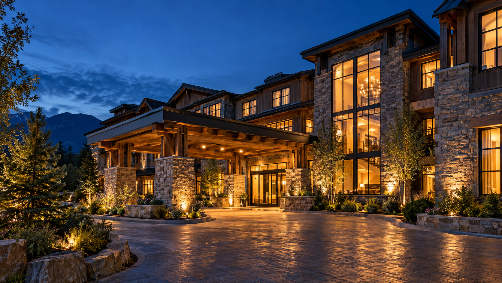 A boutique hotel at blue hour with warmly lit windows and a welcoming entrance.